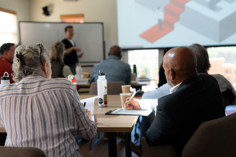 Leaders listen attentively during a session